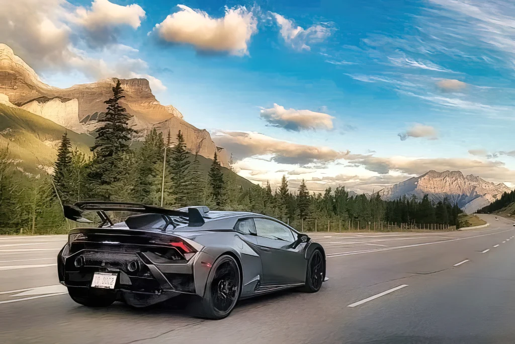 Lamborghini Huracan STO from the rear on an Alberta highway with the Rockies behind